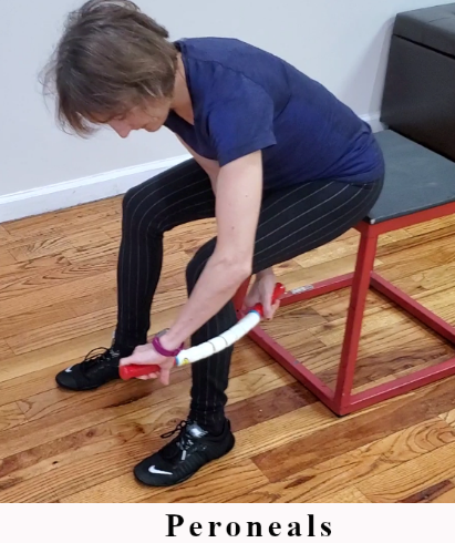 Seated trigger point release using The Stick on the peroneals.